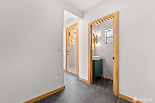 Practical entry way into main home with half bath. | Image 9