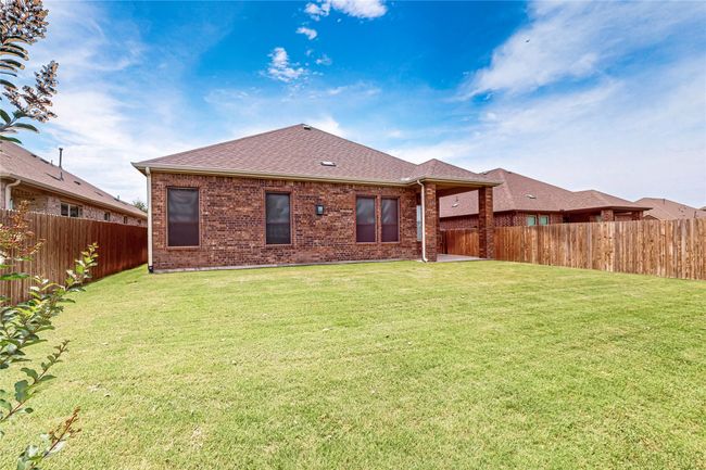 Back of house featuring brick siding, a fenced backyard, roof with shingles, and a patio area | Image 37