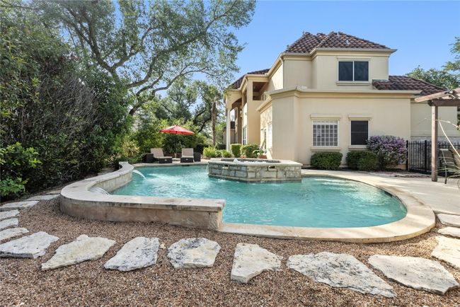 View of swimming pool with a pool with connected hot tub and a patio | Image 4