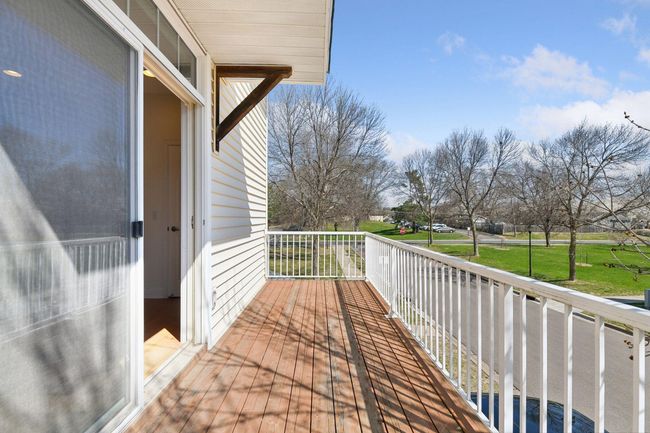 East facing view from deck overlooking open green space and public library | Image 19
