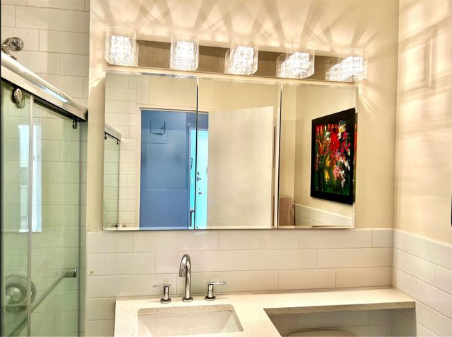 Full bath with tasteful backsplash, a tile shower, vanity, and tile walls | Image 8