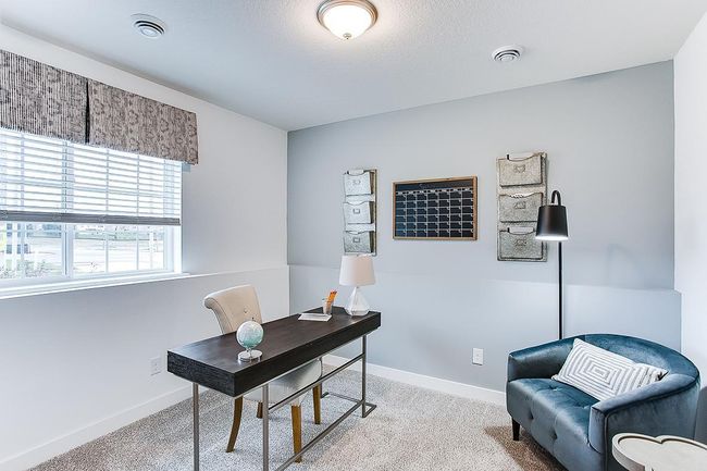 Versatile flex room located right off the entrance from the garage. Perfect for an office, storage, or non-conforming bedroom! Model picture shown. Colors and finishes may vary. | Image 15