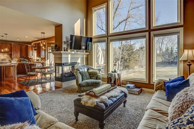 Two story great room with floor to ceiling windows overlooking your expansive yard and a 3 sided gas fireplace | Image 11