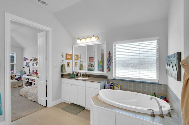 Bathroom with a stall shower, vanity, and ceiling fan | Image 18