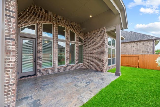 Covered back patio with attractive tile floor. | Image 33