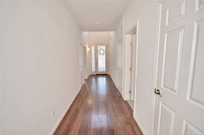 WELCOMING ENTRY GLISTENING WOOD FLOORS | Image 3