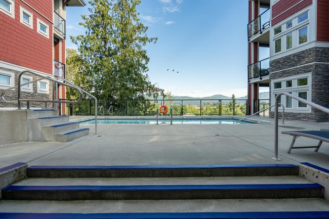 Community pool featuring a mountain view and fence | Image 12