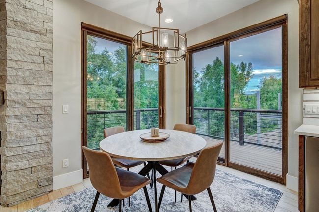 Dining space with an inviting chandelier, light wood-style flooring, and baseboards | Image 12