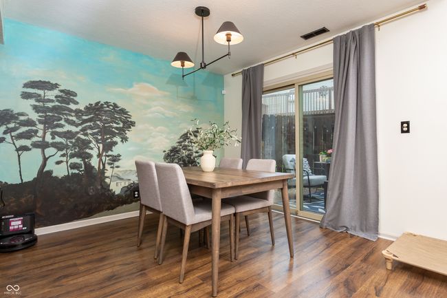 dining room with wood finished floors and baseboards | Image 11