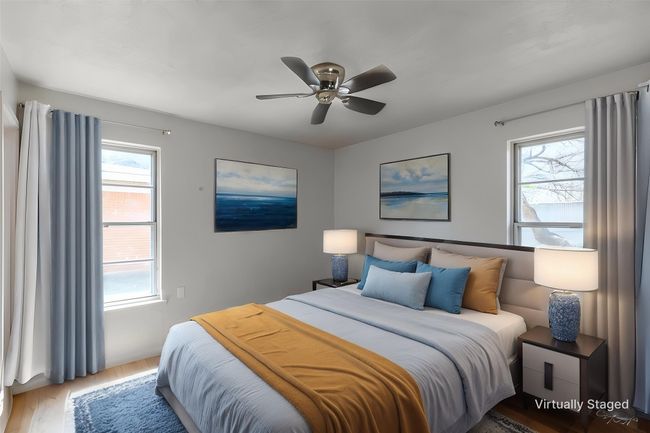Bedroom with wood finished floors and a ceiling fan | Image 6