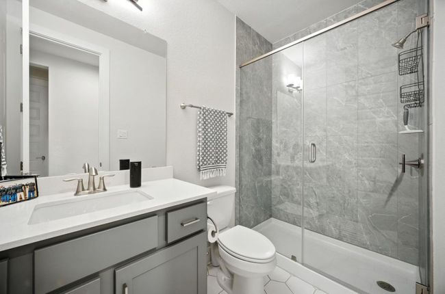 Downstairs Guest Bathroom with vanity, a stall shower, and tile patterned flooring | Image 26