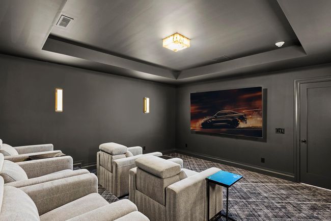Home theater room with a tray ceiling | Image 29