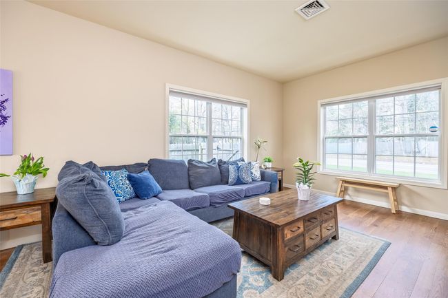 Living area featuring light wood-type flooring, visible vents, and baseboards | Image 5