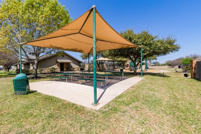 Communal playground featuring a patio and a lawn | Image 40