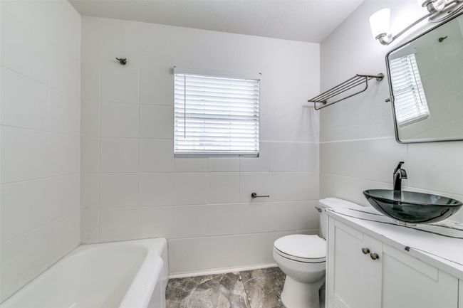 Bathroom with vanity and tile walls | Image 15