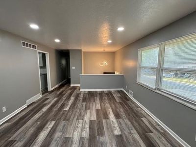 Empty room with dark hardwood / wood-style floors and a textured ceiling | Image 3