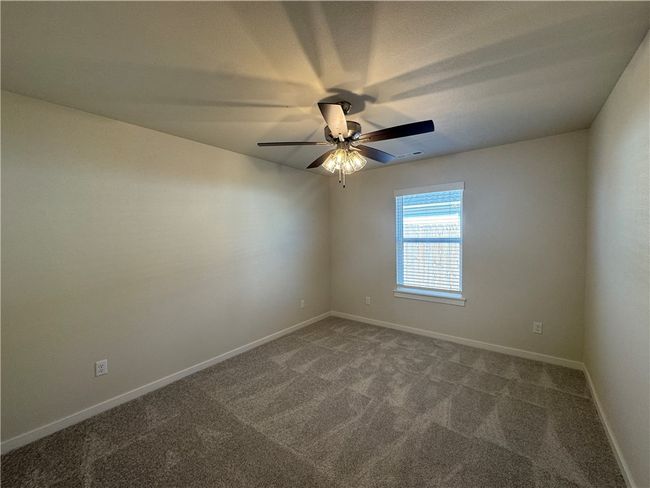 Escape to the cozy comfort of the secondary bedroom, a peaceful retreat with ample space to personalize and create your own haven. | Image 18
