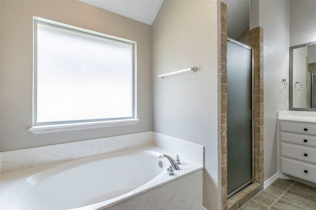 Bathroom featuring a bath, vanity, and a shower stall | Image 31