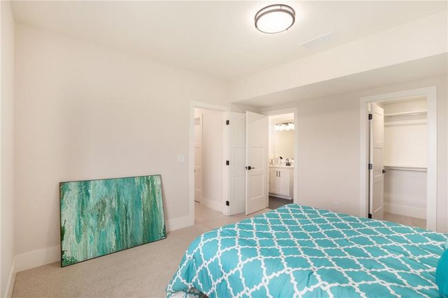 Carpeted bedroom featuring baseboards and connected bathroom | Image 29