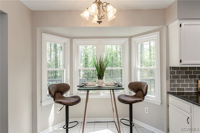 Dining area with plenty of natural light, baseboards, a chandelier, and light tile patterned flooring | Image 19