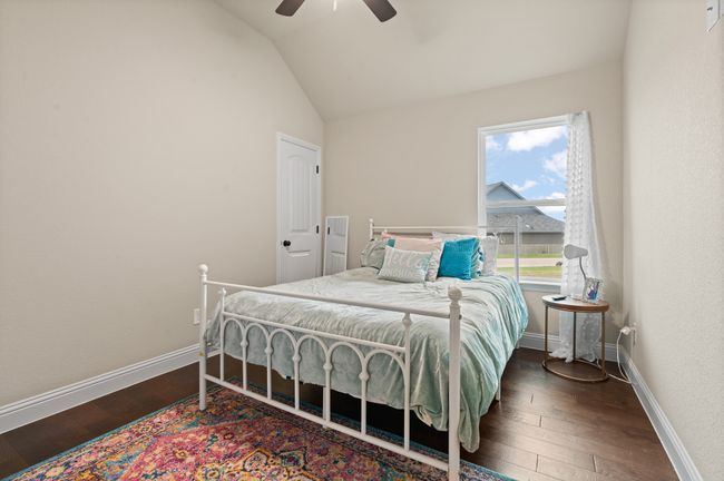 Bedroom with vaulted ceiling, wood-type flooring, and a ceiling fan | Image 19