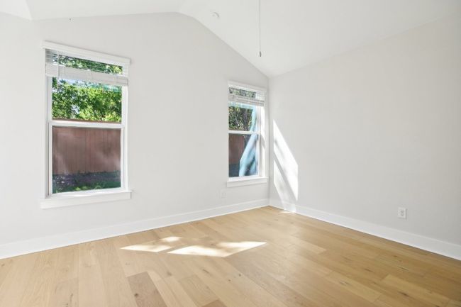 Unfurnished room featuring baseboards, vaulted ceiling, and wood finished floors | Image 32