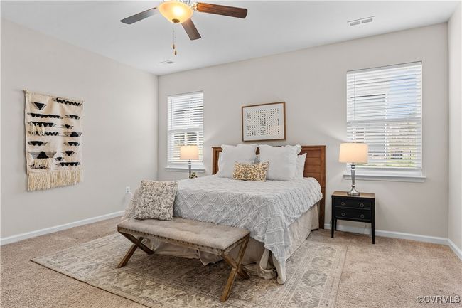 Carpeted bedroom with multiple windows, baseboards, and a ceiling fan | Image 29