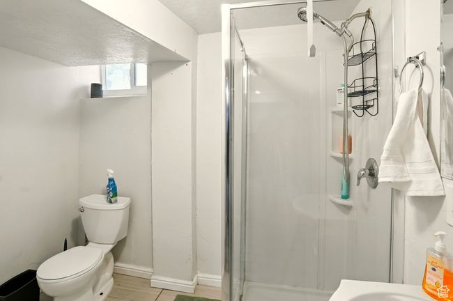 Full bath with a shower stall and wood finished floors | Image 23