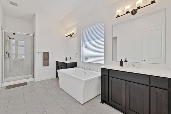 Full bath with a stall shower, two vanities, and a soaking tub | Image 26