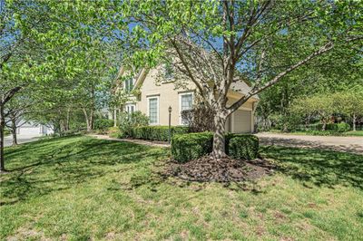 View of front facade with a garage and a front yard | Image 3