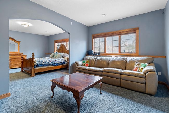 Lower-level first bedroom suite separate sitting area viewed looking toward bedroom. | Image 52
