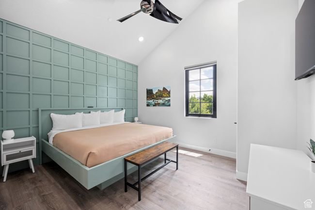 Bedroom featuring ceiling fan, hardwood / wood-style floors, and high vaulted ceiling | Image 34