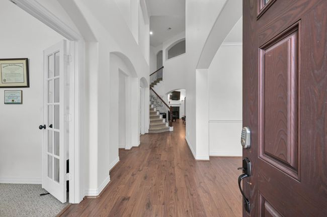Upon entering you're greeted with a grand two-story entrance and a view straight back to the living room's fireplace. To the left, you'll find the front office. To the right, the formal dining room. | Image 4