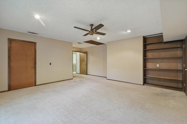 Unfurnished living room with light carpet, a textured ceiling, visible vents, recessed lighting, and ceiling fan | Image 14