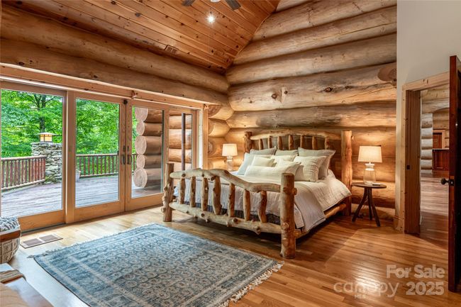 Primary bedroom on main with deck access and vaulted ceilings | Image 21
