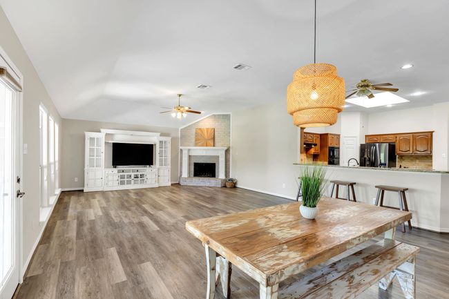HUGH FAMILY room with Brick Fireplace featuring Breakfast Bar with Bar Stools | Image 15