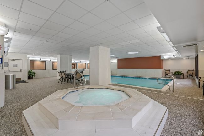 View of indoor swimming pool featuring an indoor in ground hot tub | Image 37