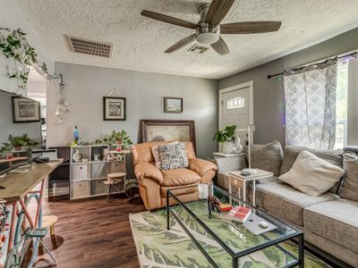 Living room featuring a textured ceiling, ceiling fan, and wood-type flooring | Image 3