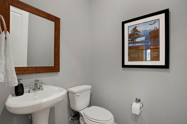Bathroom featuring toilet, a sink, and baseboards | Image 16