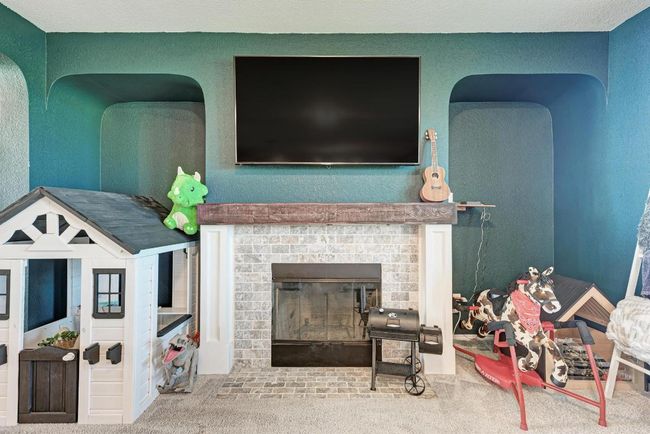 Living area featuring a brick fireplace and carpet | Image 14