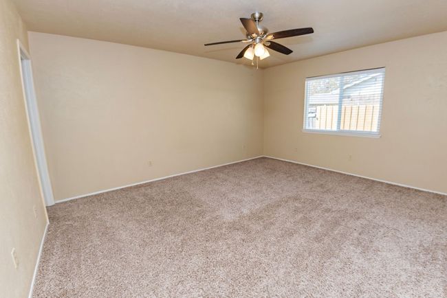 Spare room with light colored carpet and ceiling fan | Image 15