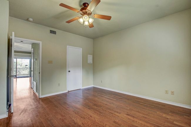 Bedroom with wood floors, a ceiling fan and natural light | Image 19