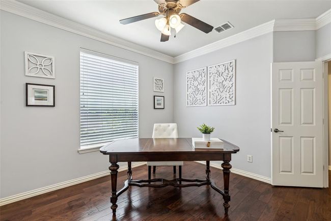 Office space featuring a healthy amount of sunlight, dark hardwood / wood-style flooring, and crown molding | Image 6