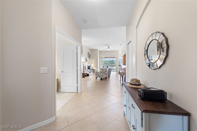 Hallway featuring baseboards and light tile patterned floors | Image 26