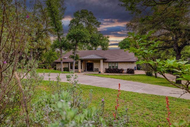 View of front of property with circle driveway, flagstone walkway and front yard | Image 9
