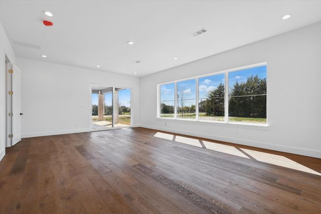 Empty room featuring visible vents, wood finished floors, and recessed lighting | Image 32