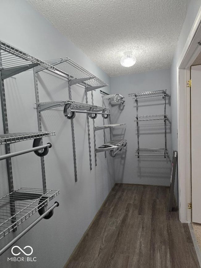 spacious closet with wood finished floors | Image 24
