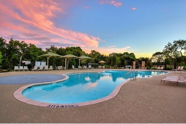 Pool at dusk with a community pool and a patio area | Image 40
