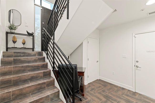 BONUS AREA LEADING FROM GARAGE WITH STORAGE AND STAIRS LEADING TO COMMON AREA AND BALANCE OF CONDOMINIUM UNIT | Image 34
