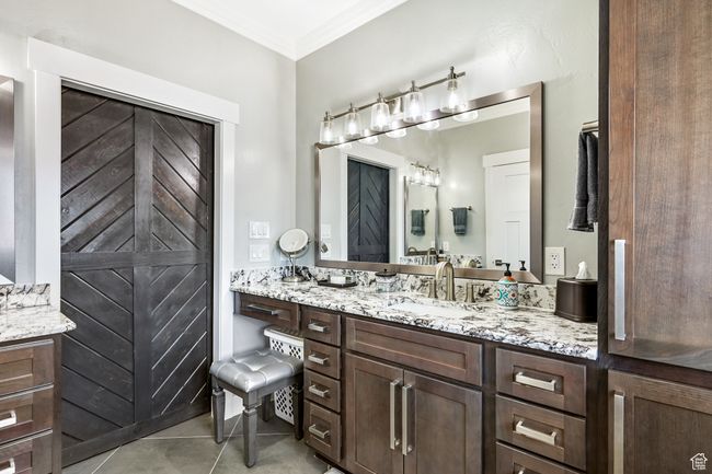 Bathroom featuring vanity, ornamental molding, and tile patterned floors | Image 41